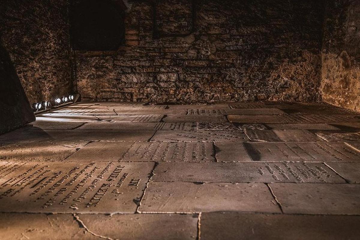 a dark room with a stone floor with writing on it