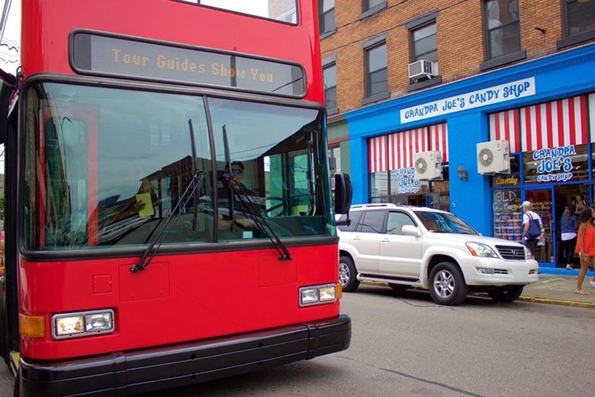 a red bus is driving down a city street
