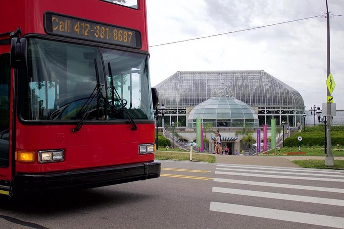 a red double decker bus driving down a street