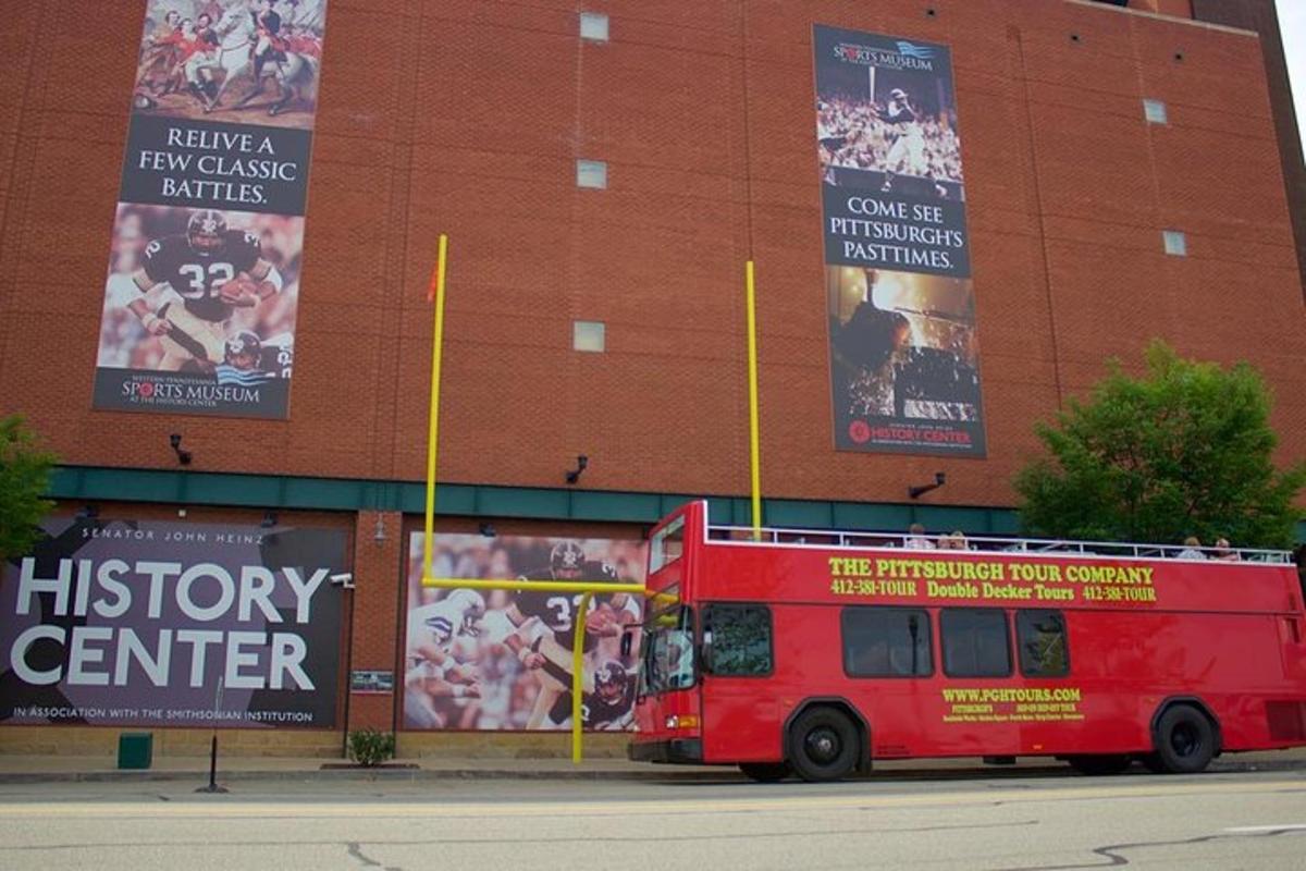 a red bus parked in front of a building