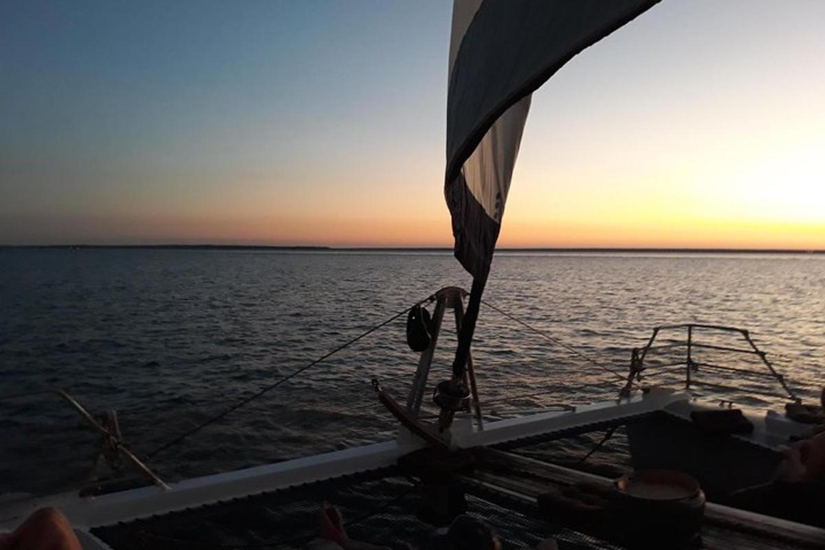 a boat in the water with the sun setting