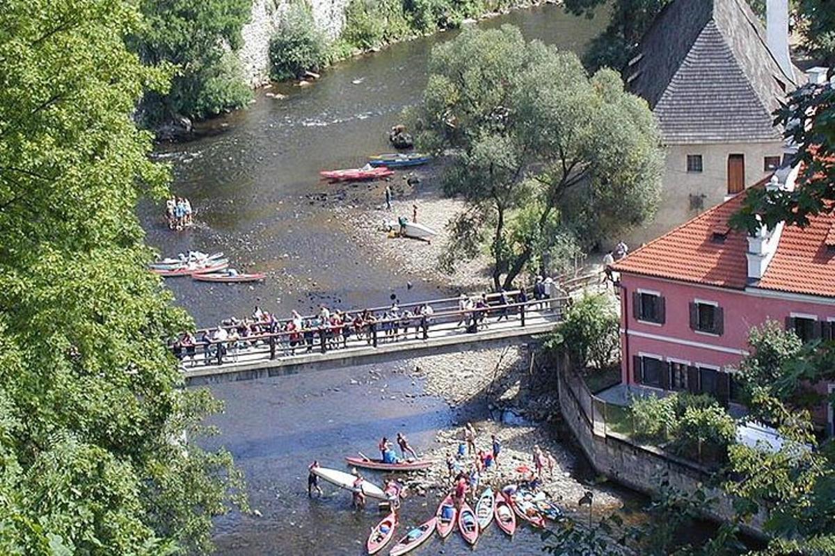 a group of people on a bridge over a river