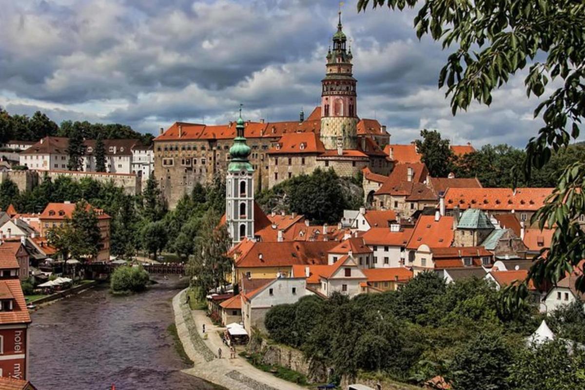 a view of a city with a river and a castle