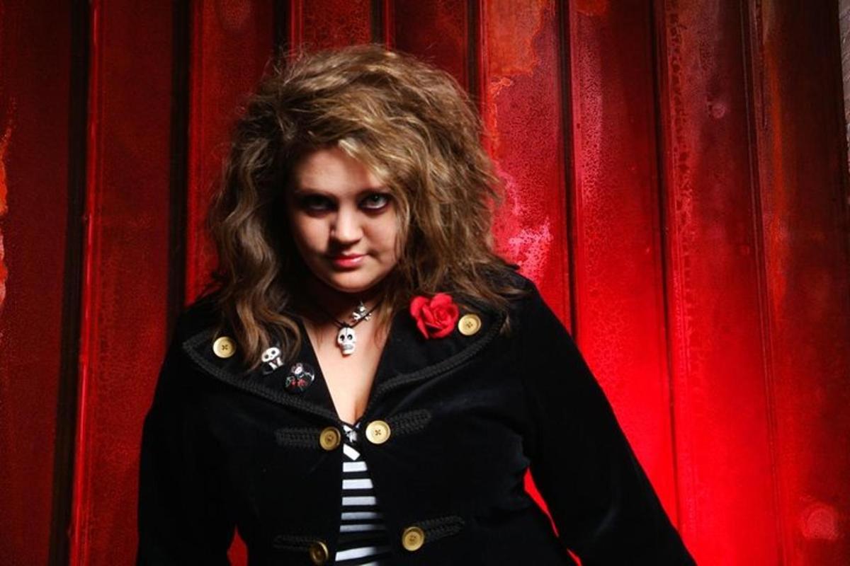 a woman with long hair wearing a black jacket