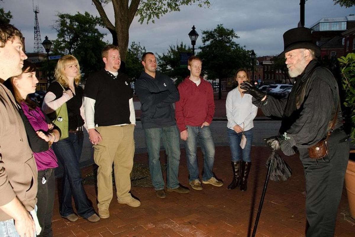 a group of people standing around a man with a camera