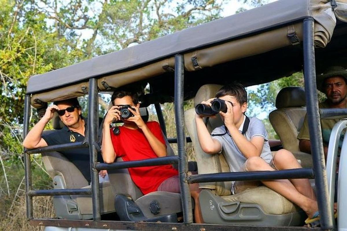 a group of men taking pictures while riding in a vehicle