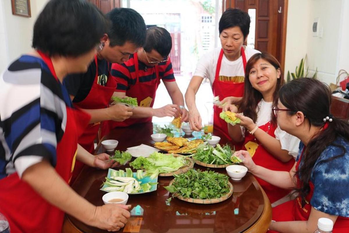 a group of people standing around a table eating food