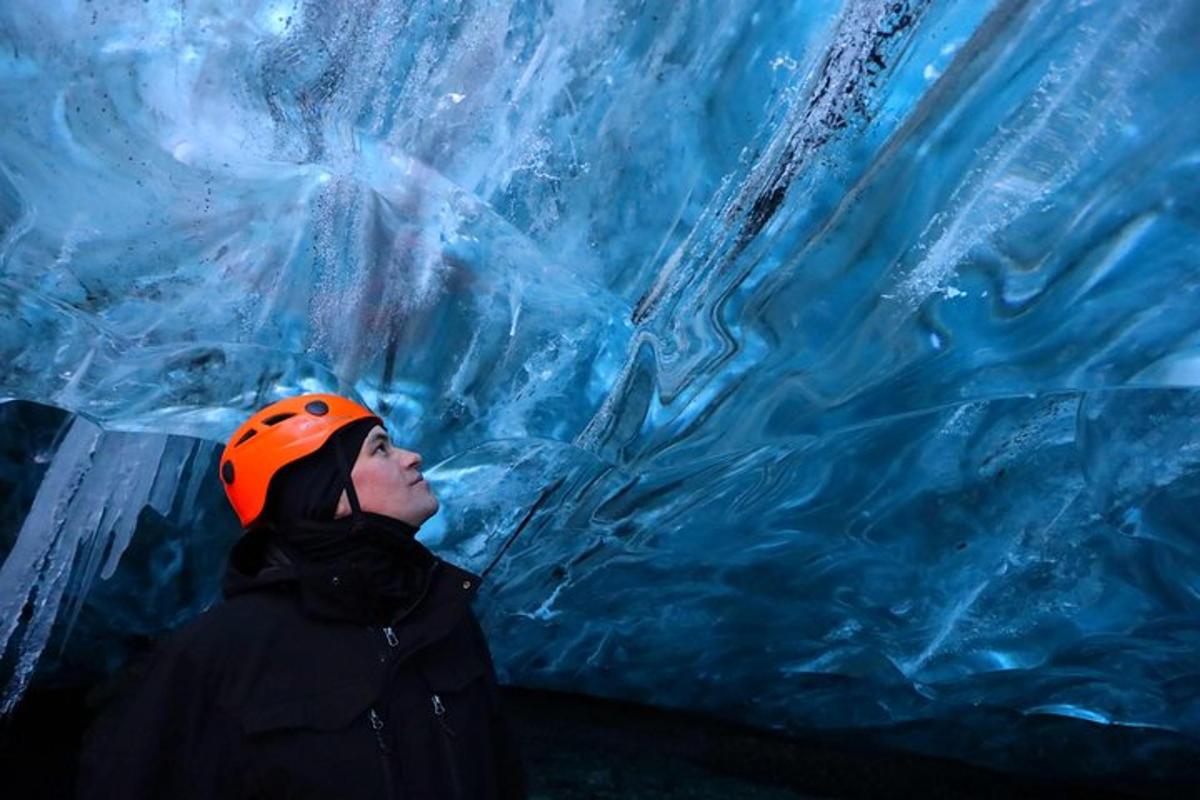 a woman standing in front of a ice cave