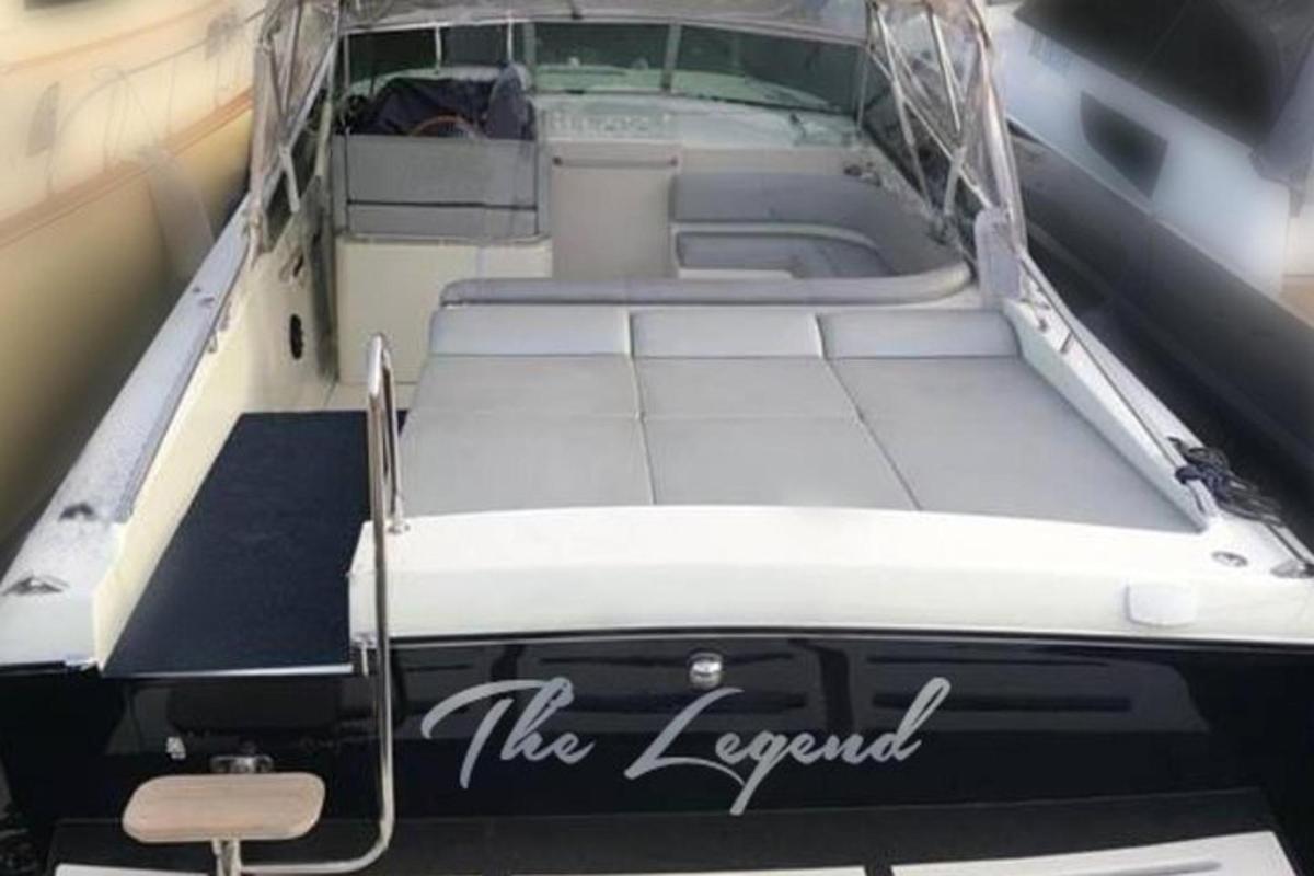 a white boat with the legend written on the back of it