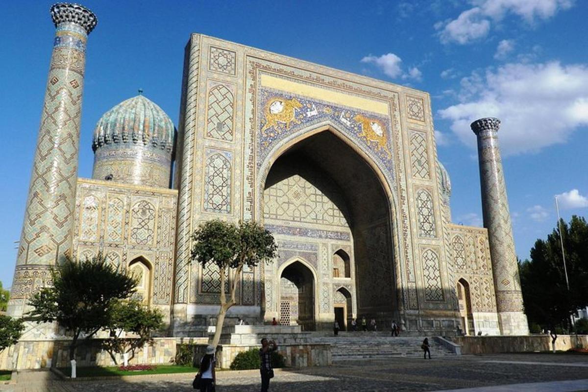 a large building with an arch and two domes
