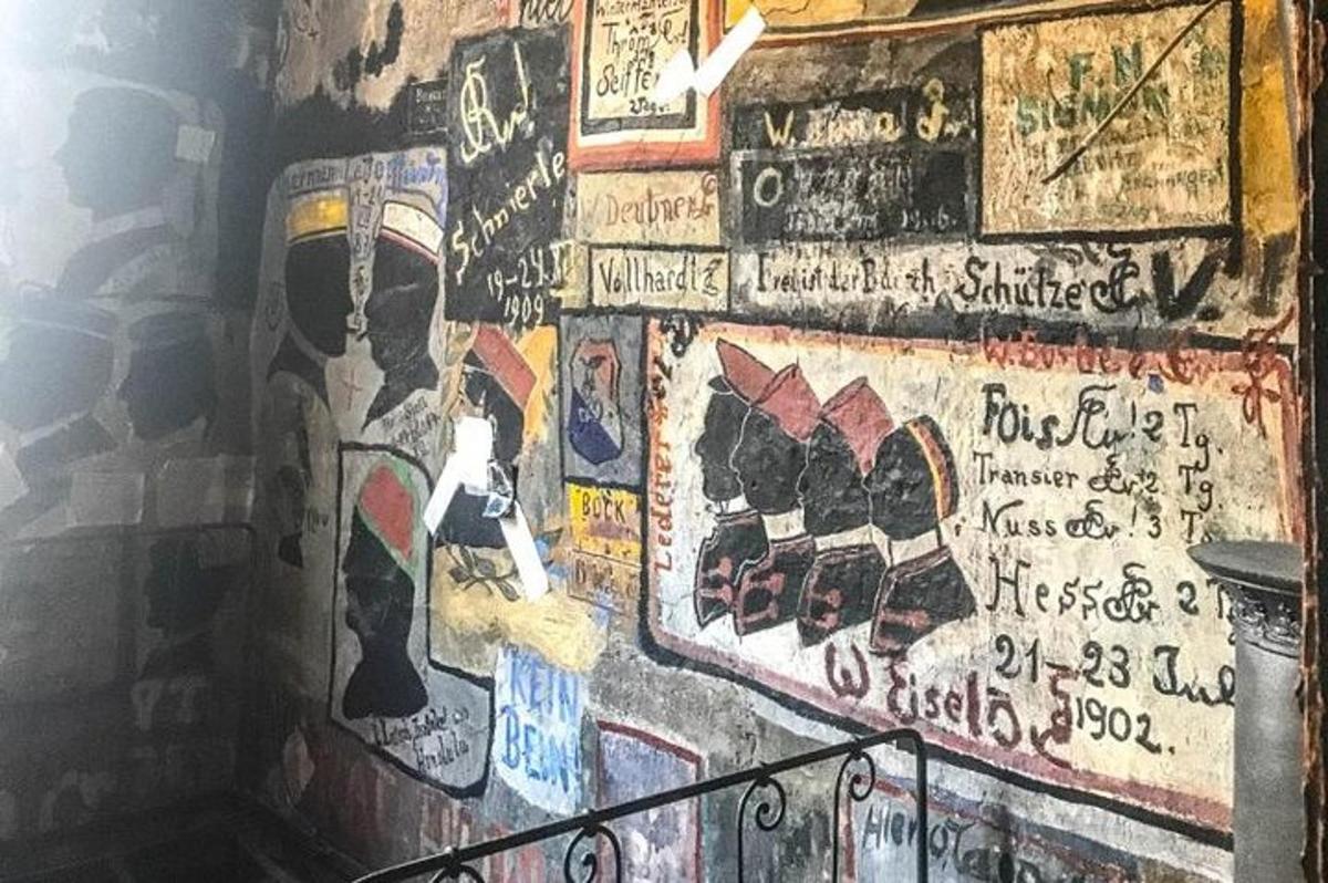 a wall with alot of graffiti on it