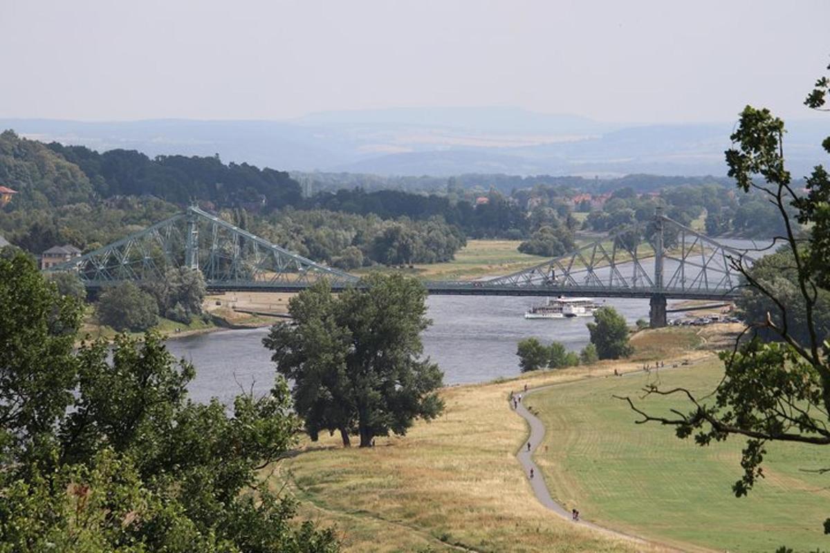 a bridge over a river with a boat in it