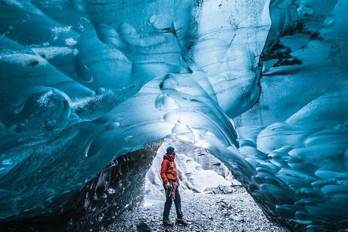 a person standing inside of an ice cave
