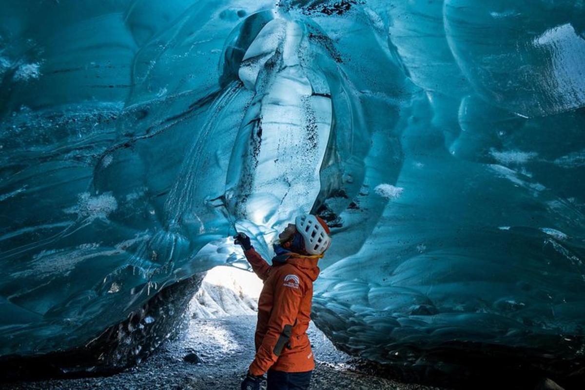 a child is standing in front of an ice cave