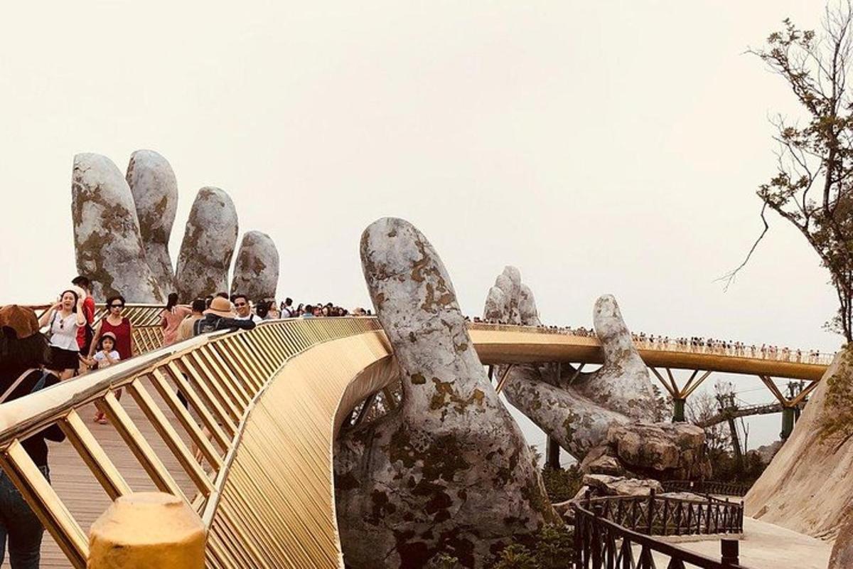 a large statue of a hand on a bridge