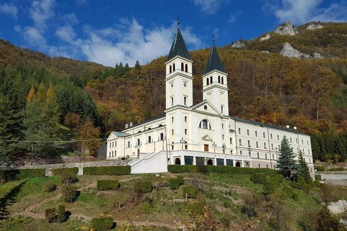 a large white building with a tower on top of a hill