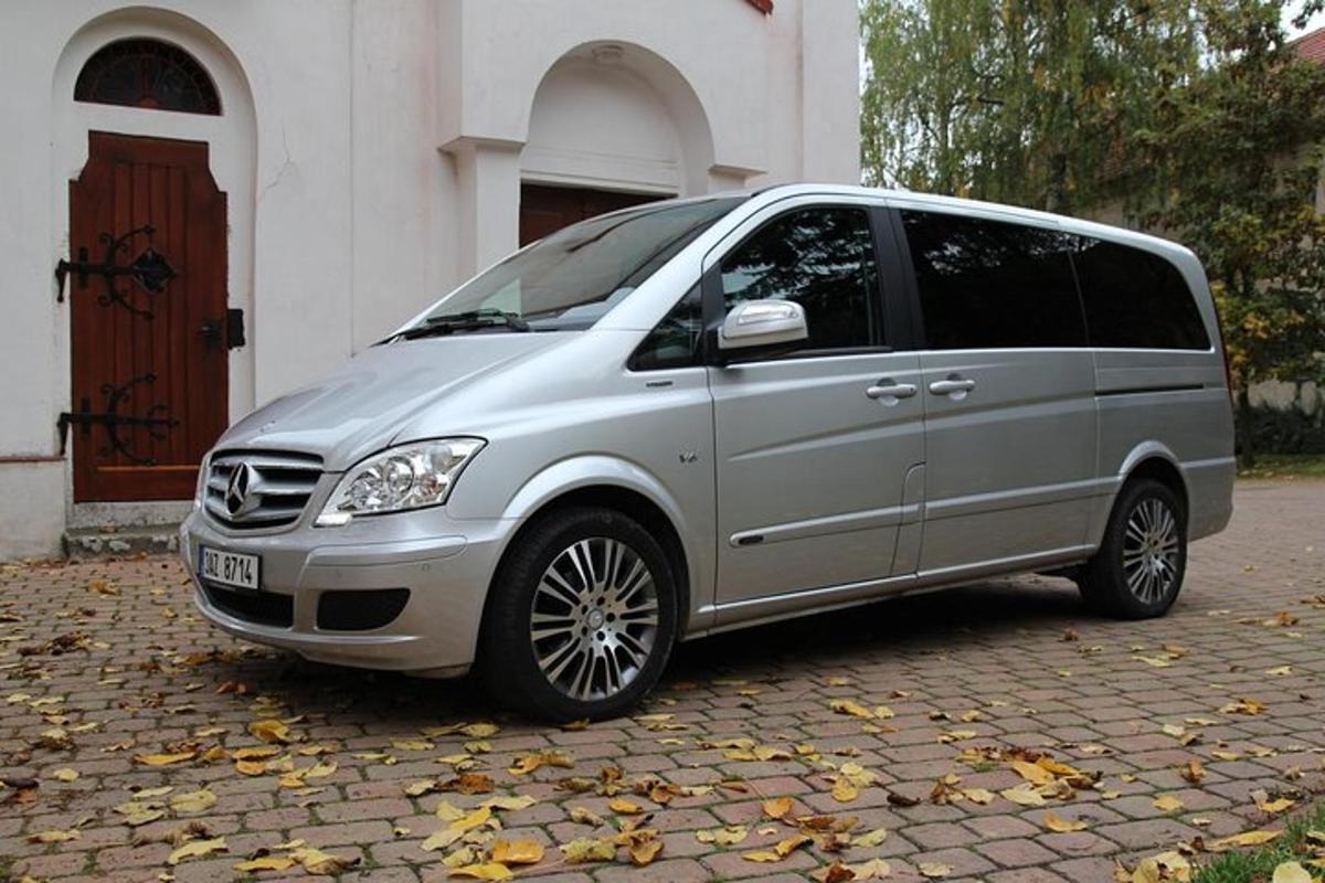 a silver van parked in front of a building