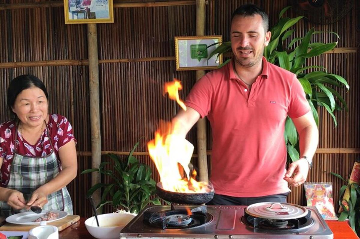 a man and a woman standing next to a grill with fire