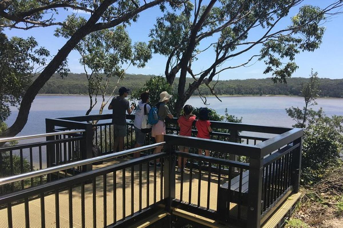 a group of people standing on a bridge overlooking a river