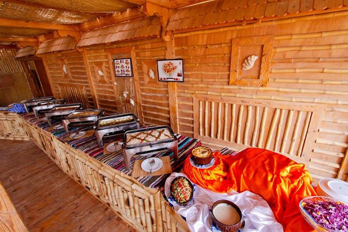 a room with a long table in a log cabin