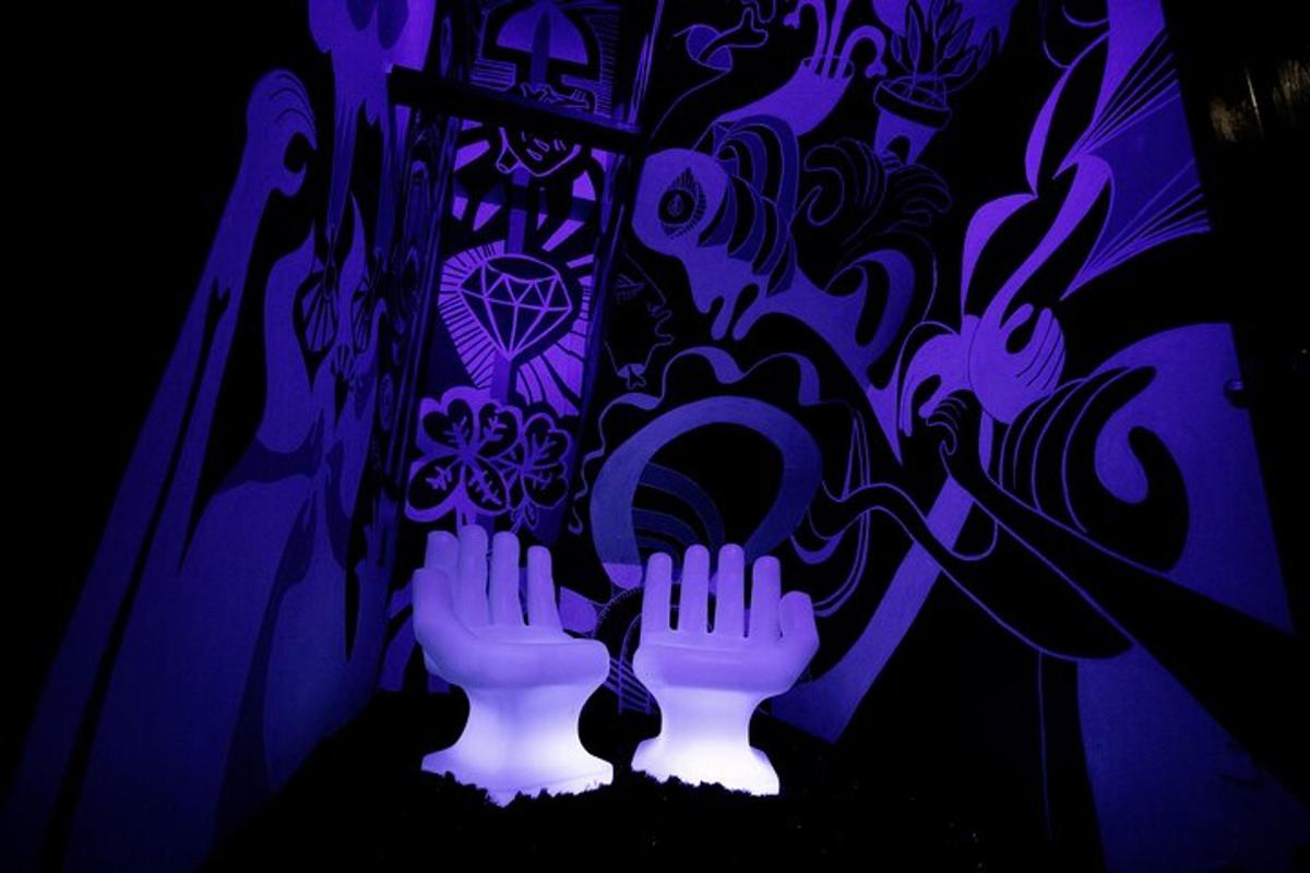 a couple of white vases with their hands in front of a wall