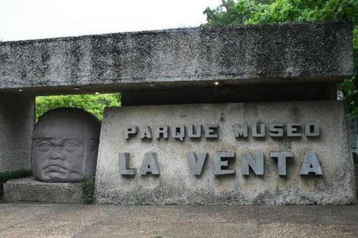 a statue of a head on top of a monument