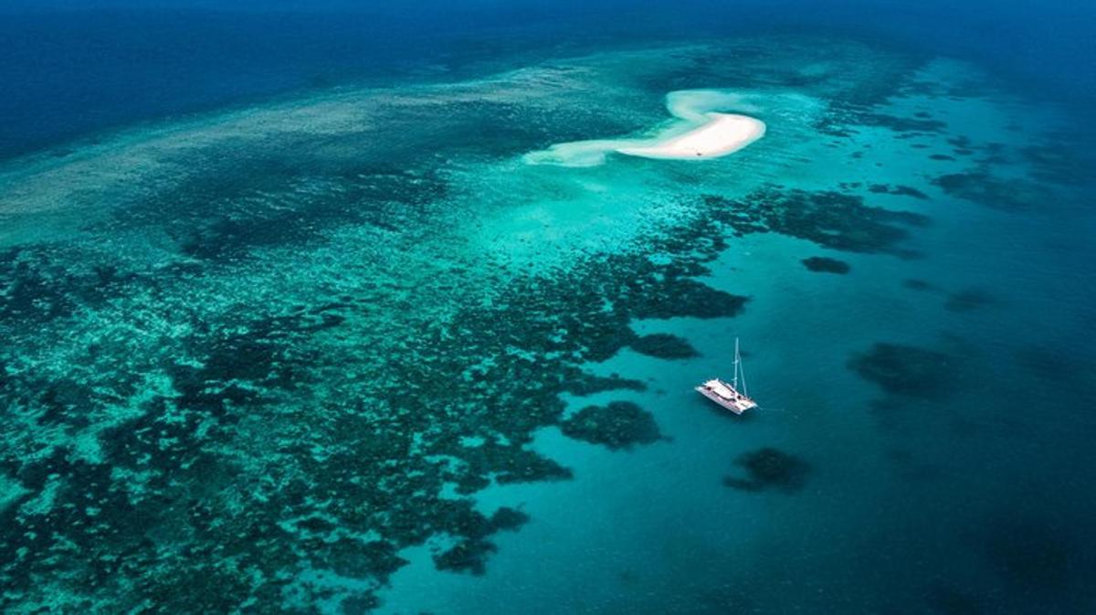 an aerial view of a boat in the ocean