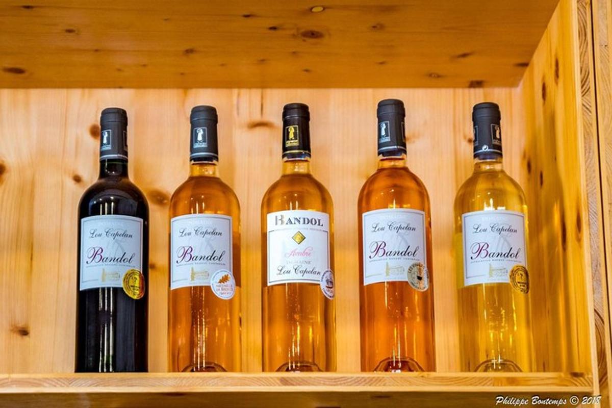 a row of wine bottles on a wooden shelf