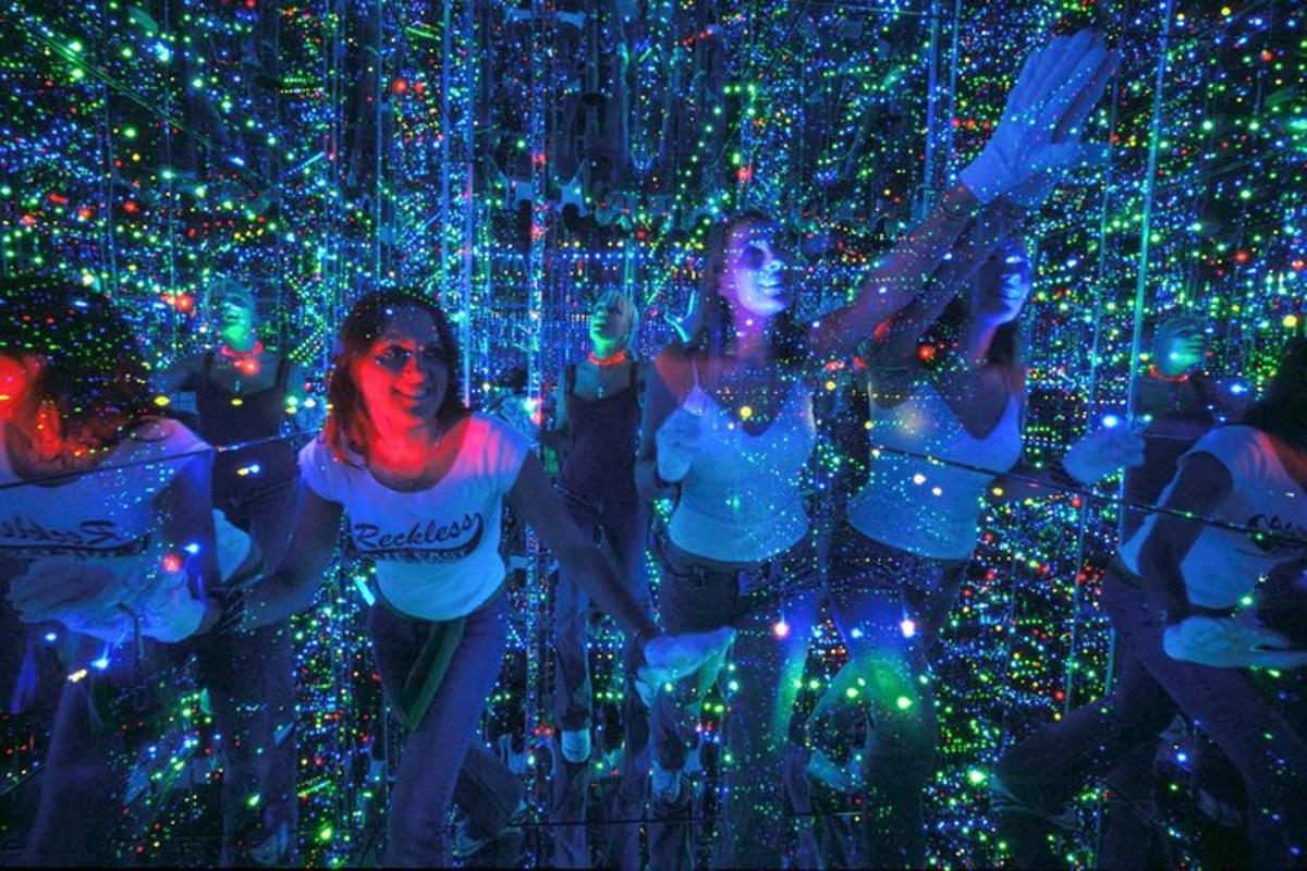 a group of women standing in front of lights