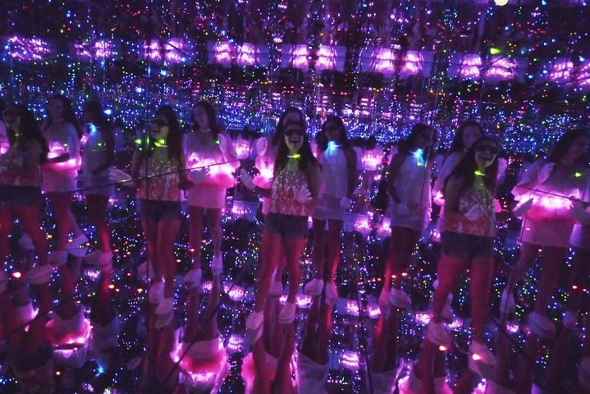 a group of girls standing in front of lights