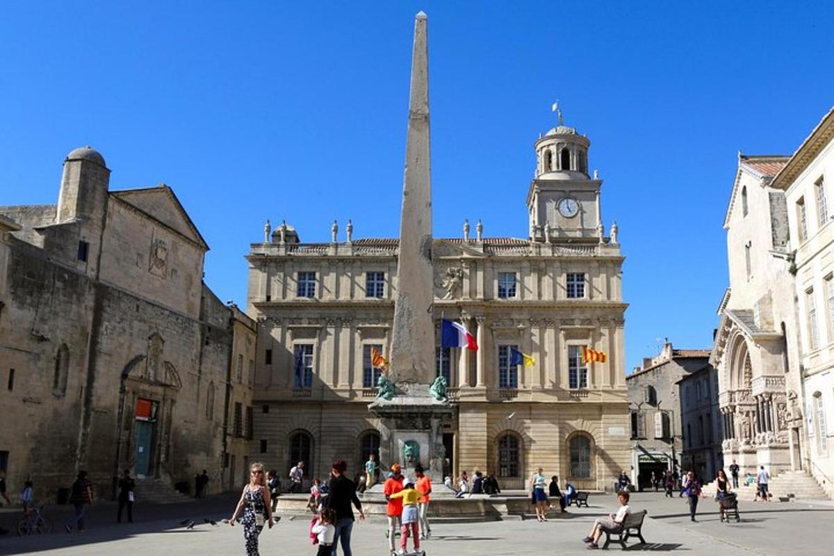 a building with a clock tower in the middle of a street