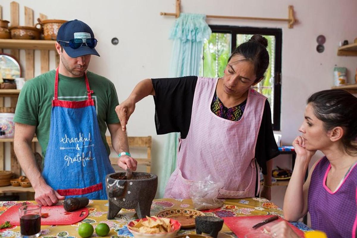 a man and woman standing in a kitchen preparing food