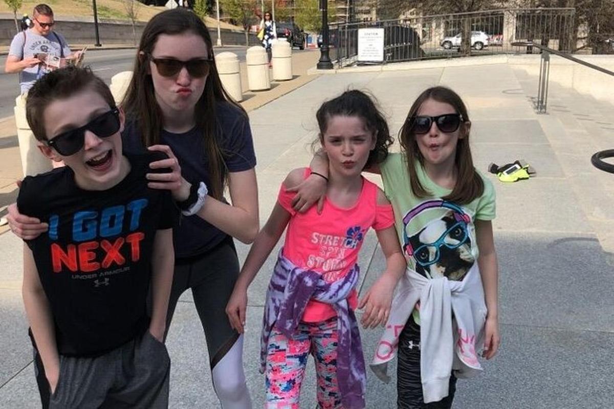 a group of three young people posing for a picture