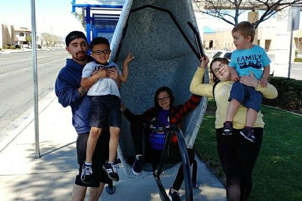 a group of people standing next to a wall