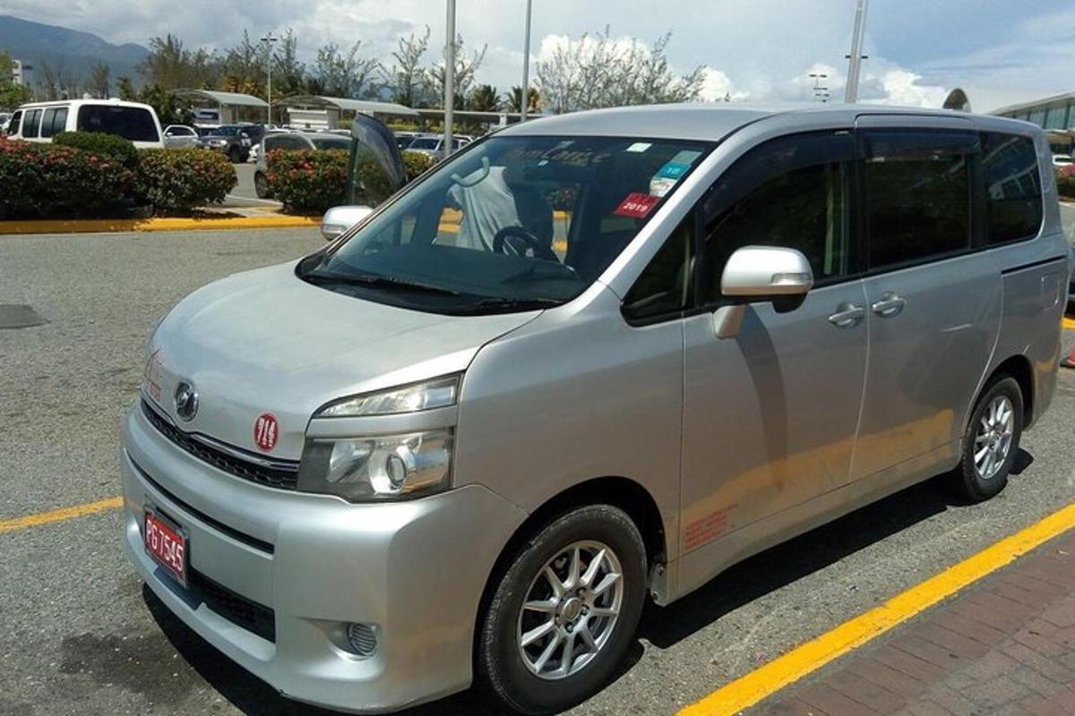 una petita furgoneta platejada aparcada en un aparcament