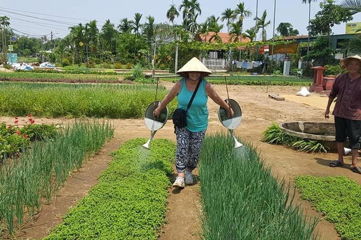 a woman wearing a straw hat standing in a field
