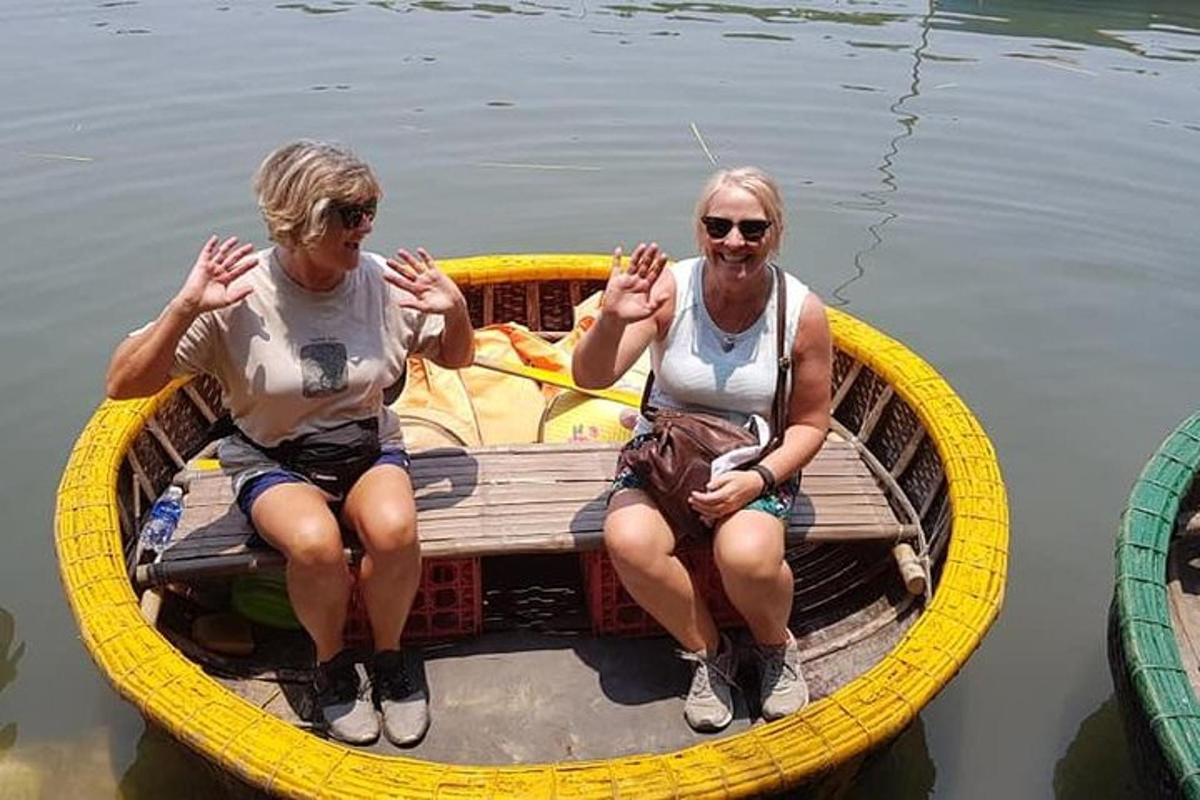 two people sitting in a yellow boat in the water