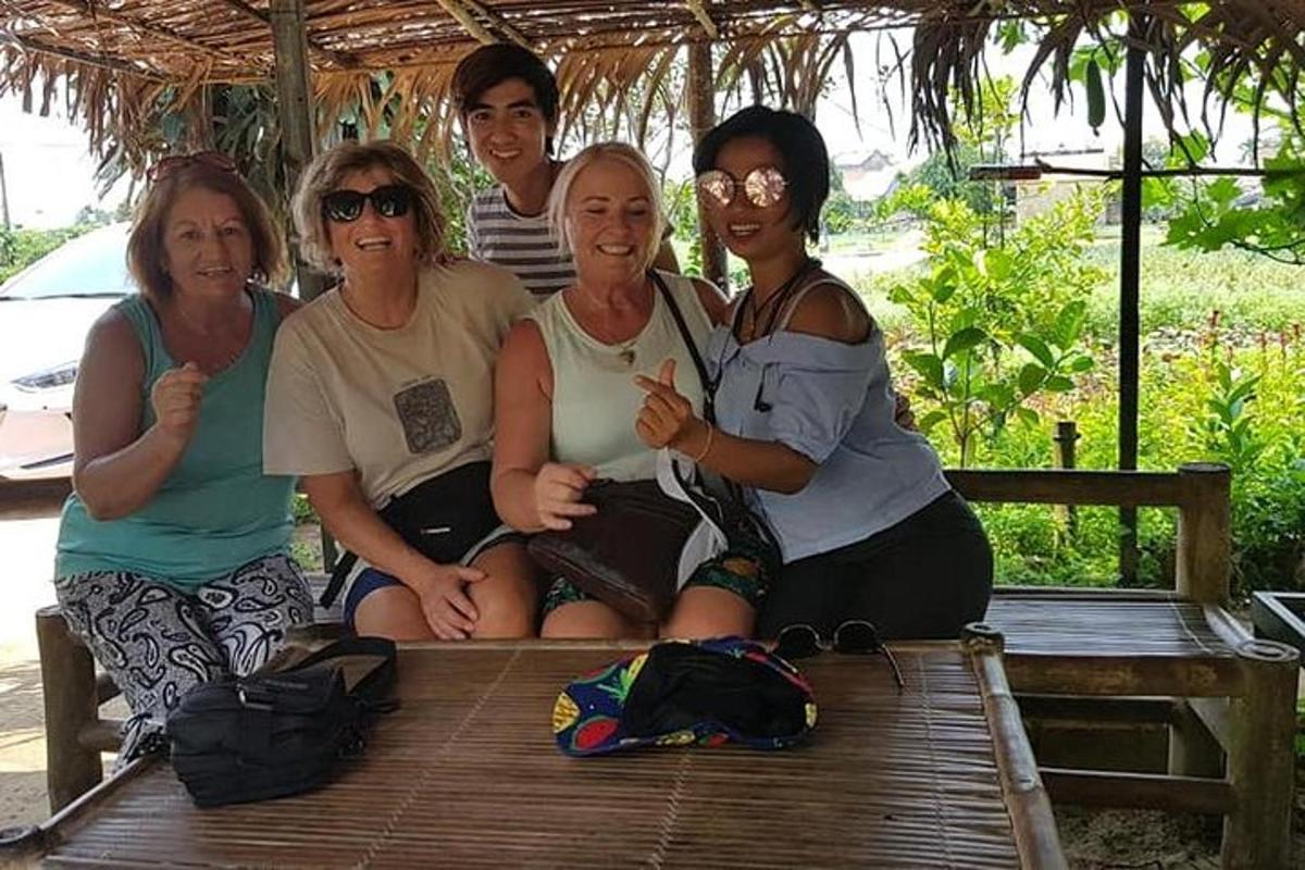 a group of people sitting on a wooden bench