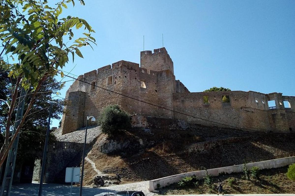 an old castle sitting on top of a hill