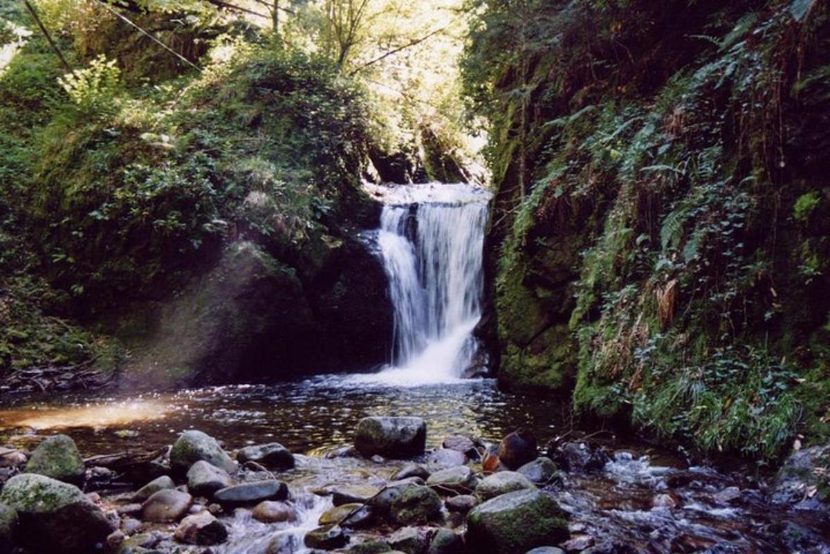 a waterfall in the middle of a river with rocks