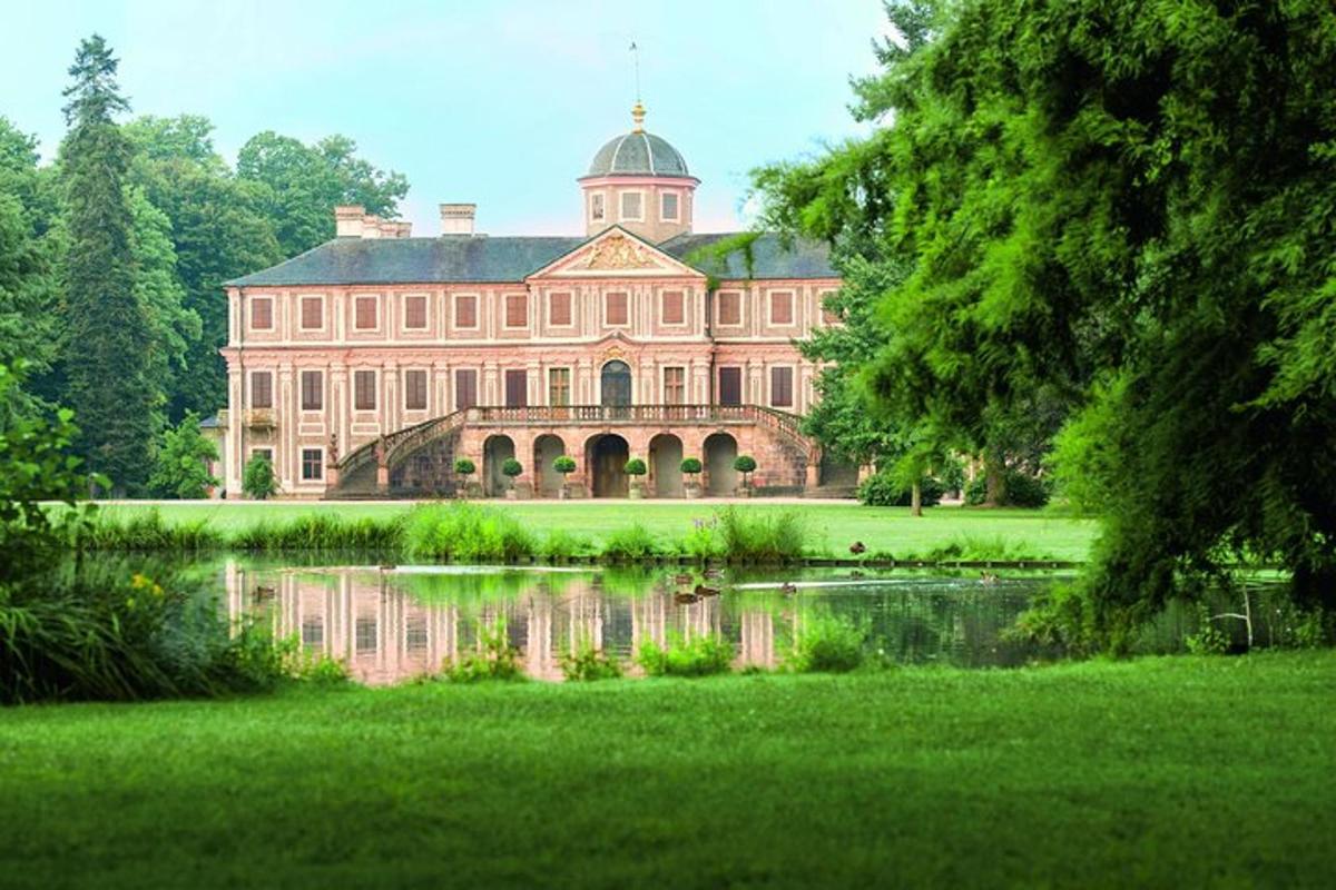 a large building with a pond in front of it