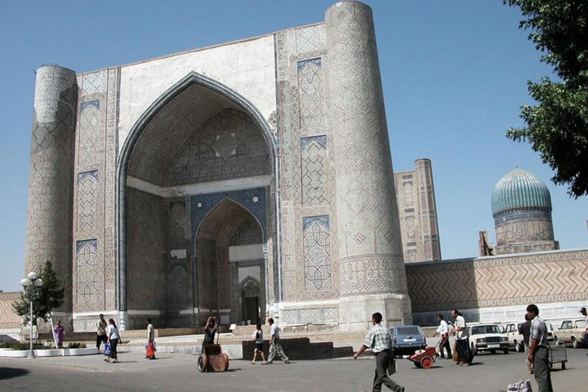 a large building with people walking in front of it