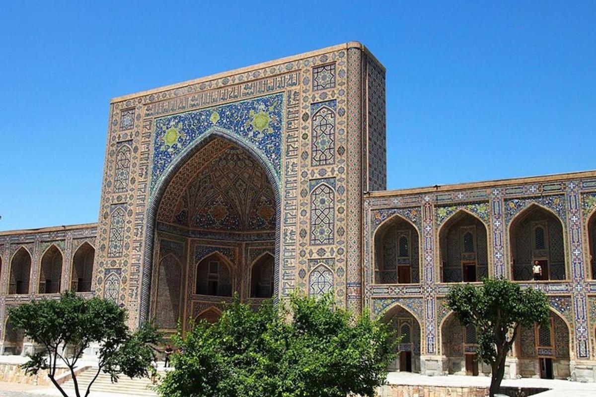 a large building with an arch in front of it