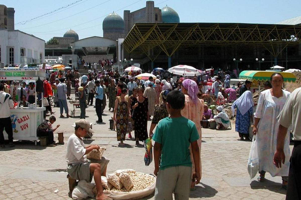 a large crowd of people walking around a market