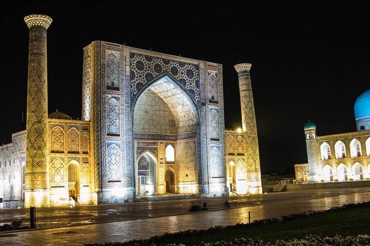 a large building with a lit up building at night