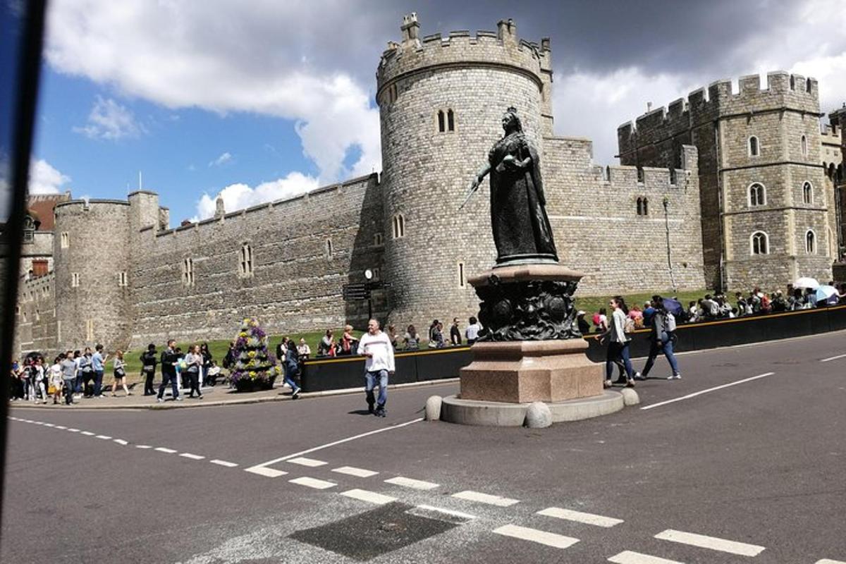 a crowd of people walking in front of a castle