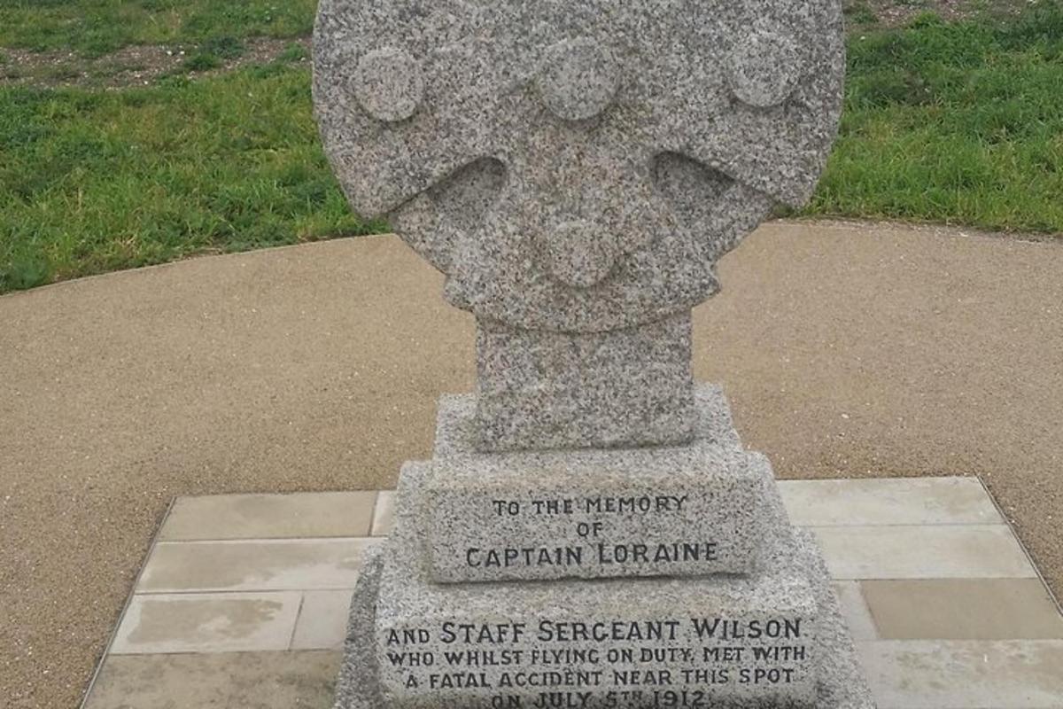 a statue of a head on top of a sidewalk