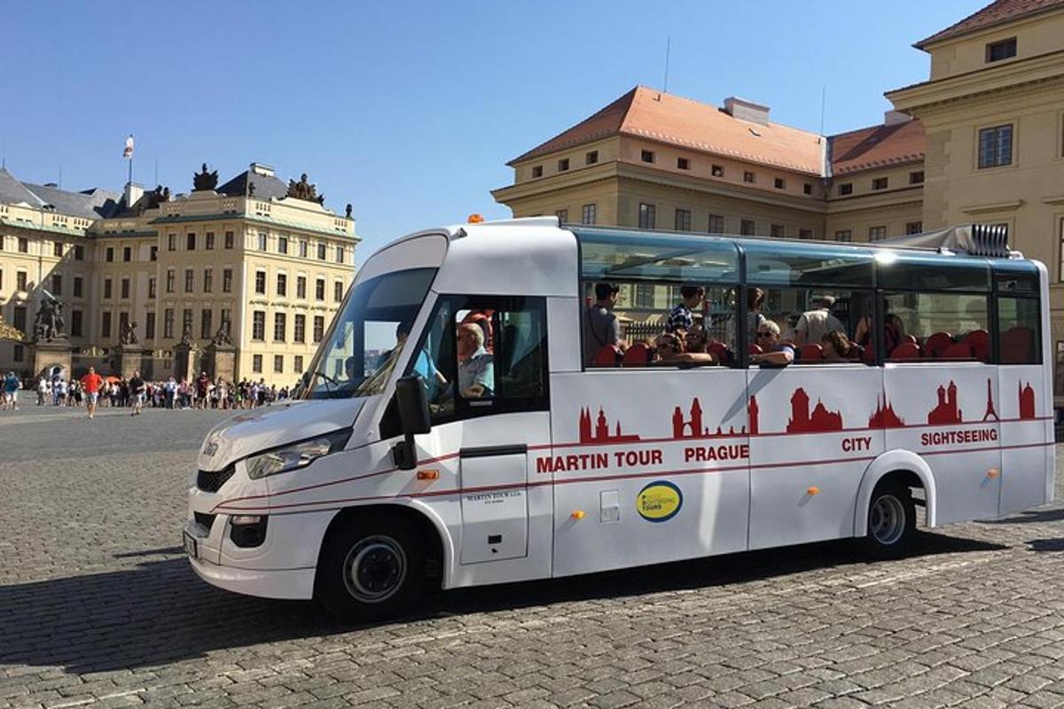 a white bus parked in front of a building