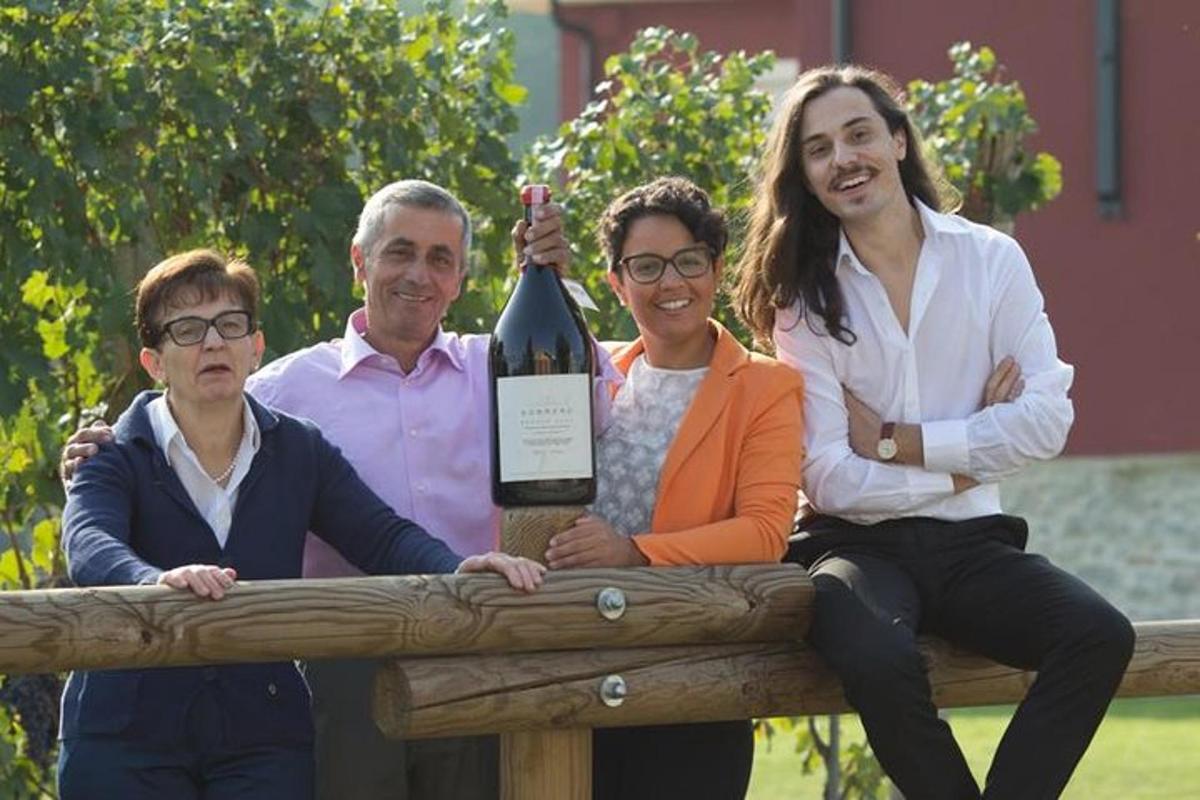 a group of people holding up a bottle of wine