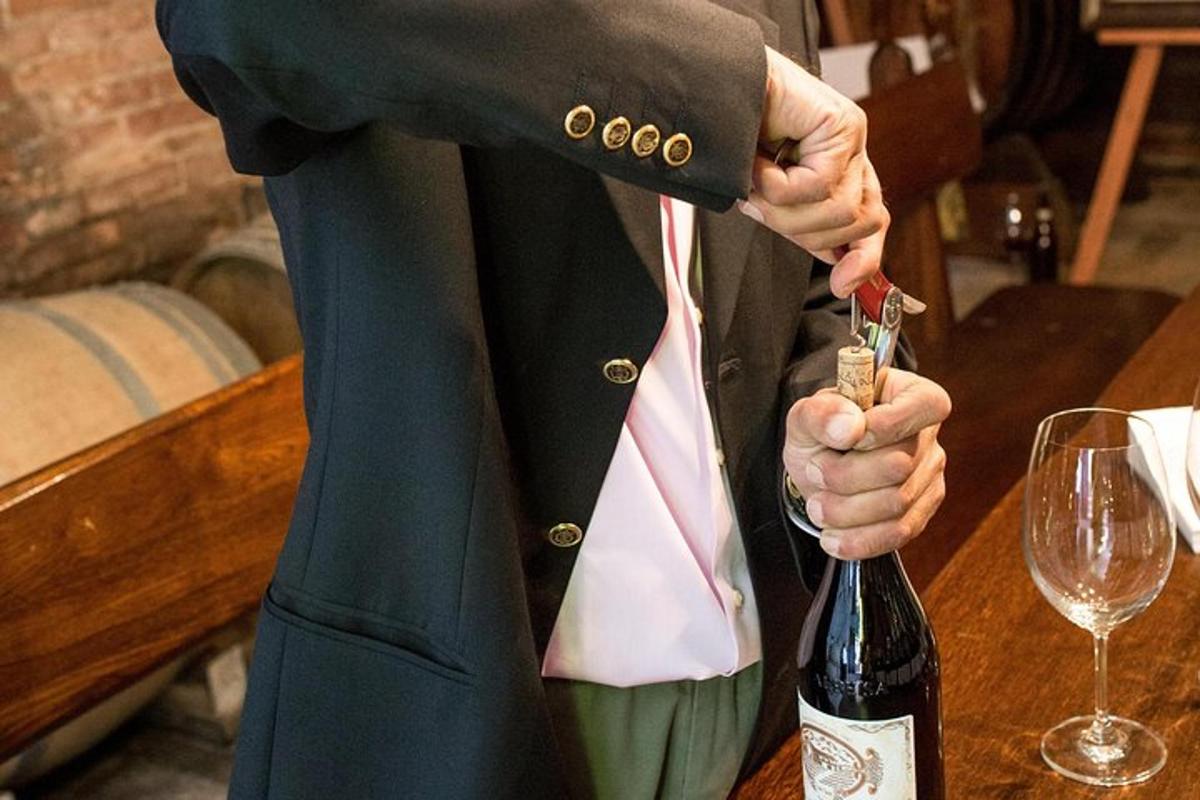 a person is opening a bottle of wine